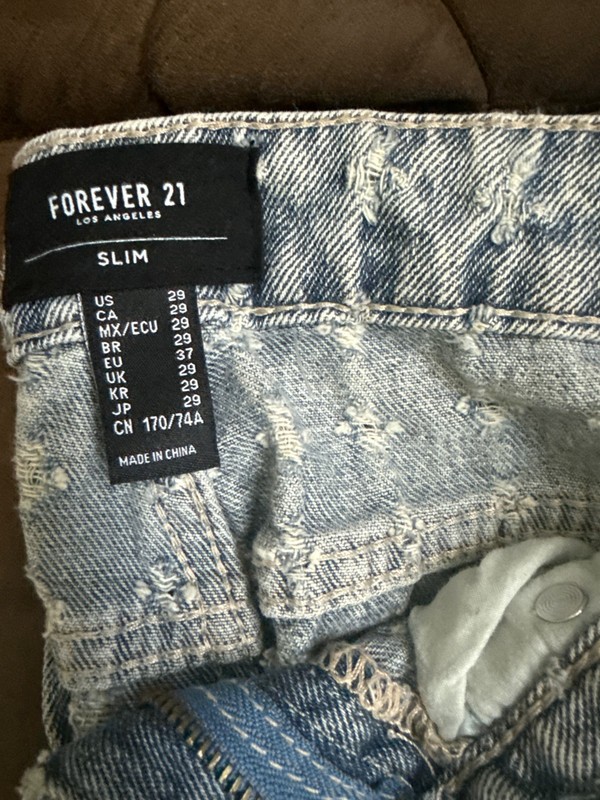 Heavily distressed jeans : The denim features allover horizontal and vertical mi gallery